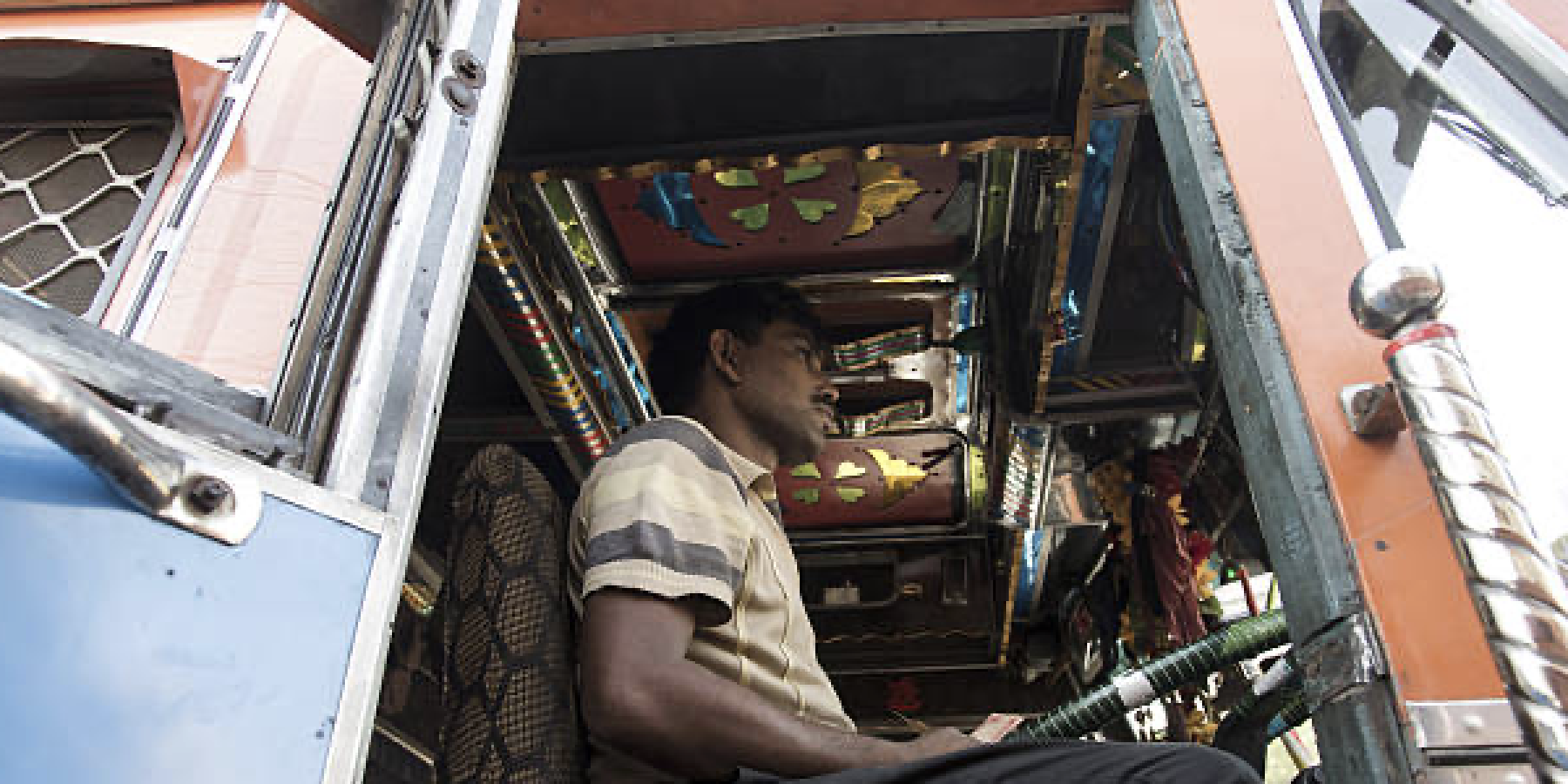 Commercial truck driver using telematics-enabled fleet management to improve fuel efficiency and reduce emissions