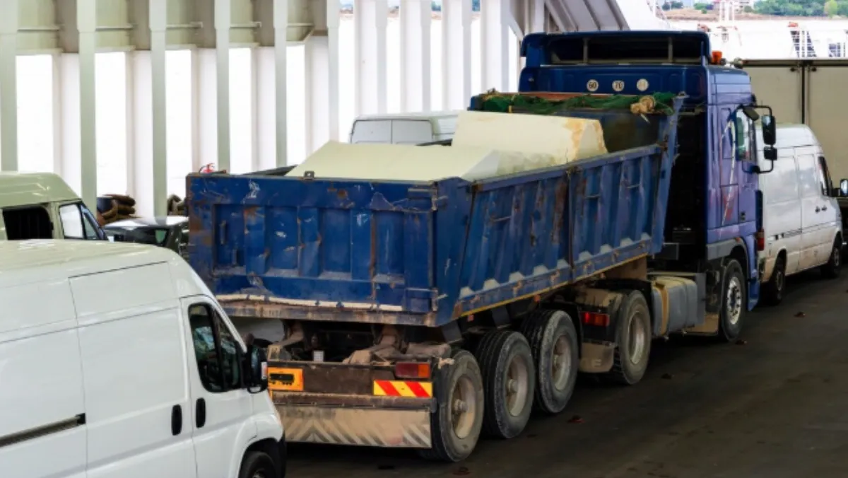 Dump truck carrying construction materials on a highway, illustrating fleet transport and heavy-duty logistics operations.