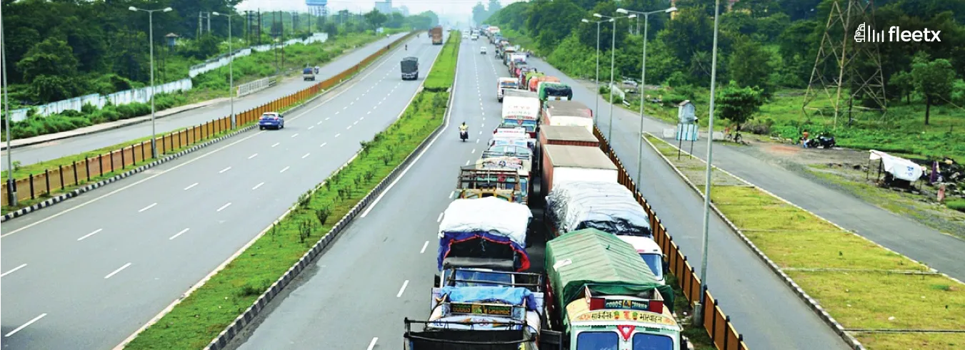 Traffic congestion with commercial trucks on a highway, highlighting fleet movement and transportation logistics challenges.