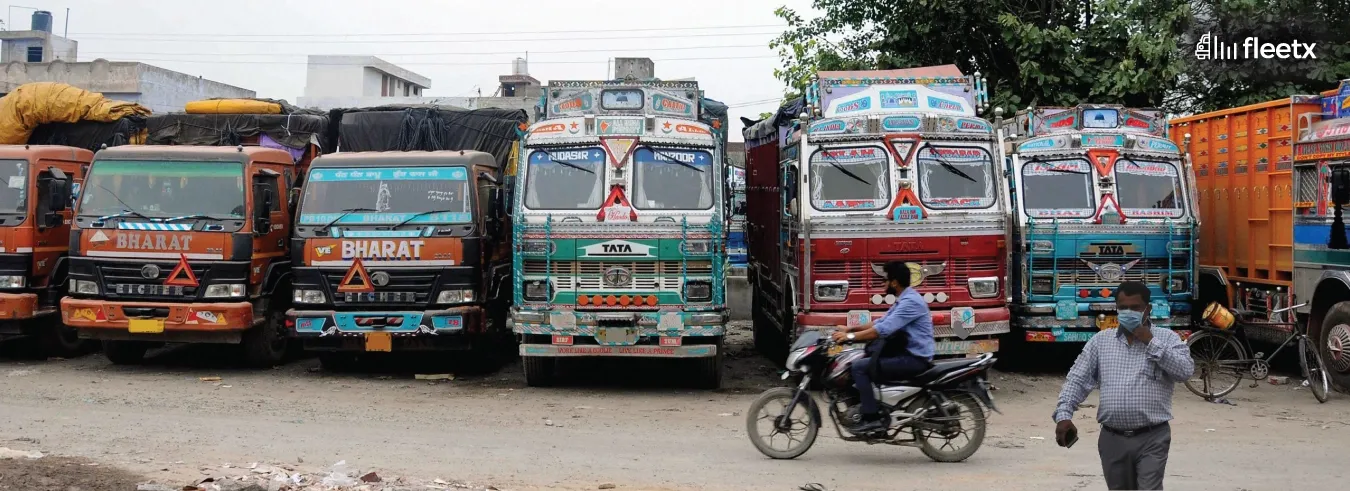 Fleet of commercial trucks parked at a transport yard, representing fleet operations and logistics management in India.